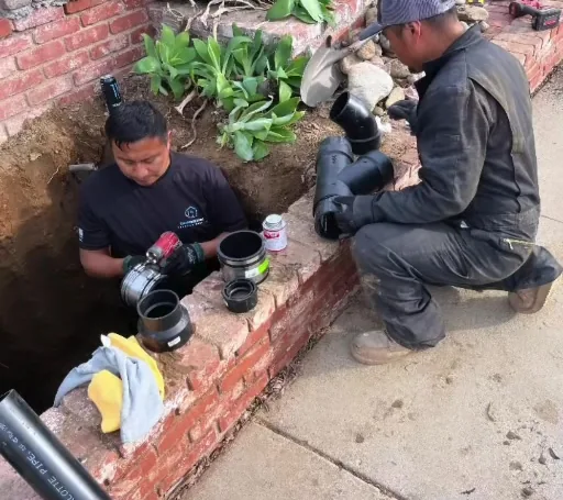 Drain Doctors crew working at an excavated sewer access point in Simi Valley