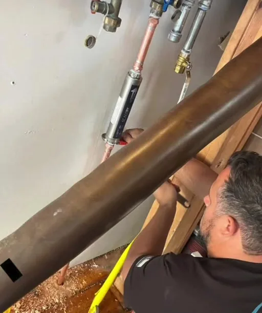 Drain Doctors technician working on water-heater supply piping